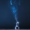 An image of a needle electrospinning fibers into solution-processed electronic thin films.